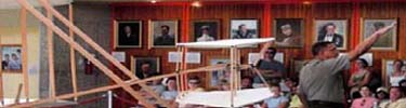 Park ranger demonstrates the reproduction Wright Flyer